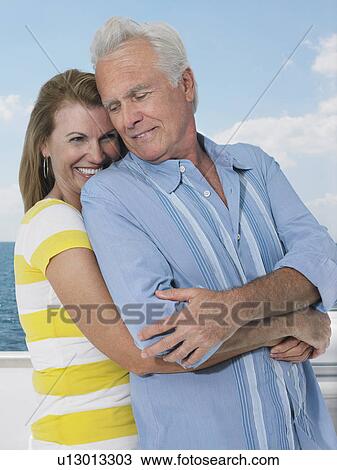 Middle-aged couple embracing on yacht View Large Photo Image Stock Image - Middle-aged couple embracing on yacht. Fotosearch