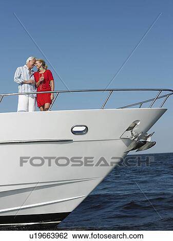 Middle-aged couple standing in bow of yacht View Large Photo Image Stock Image - Middle-aged couple standing in bow of yacht. Fotosearch