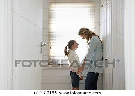 Mother and daughter standing face to face by window, half length View Large Photo Image Stock Photography - Mother and daughter standing face to face by window, half length. Fotosearch