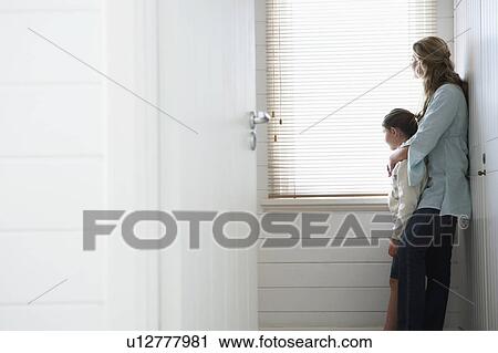 Mother and daughter standing looking out of window View Large Photo Image Stock Image - Mother and daughter standing looking out of window. Fotosearch