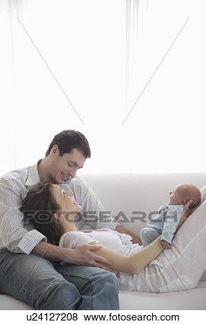 Stock Photo - Mother and father with newborn baby. Fotosearch