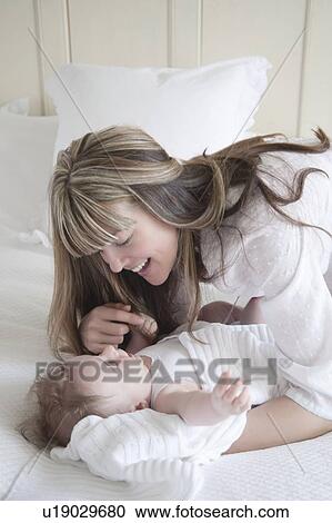 Mother smiles at her baby boy View Large Photo Image Stock Image - Mother smiles at her baby boy. Fotosearch