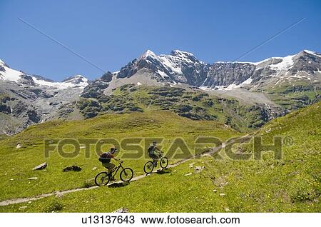 Mountain biking in the Val de Bagnes, Switzerland near the Cabane de Chanrion View Large Photo Image Stock Image - Mountain biking in the Val de Bagnes, Switzerland near the Cabane de Chanrion. Fotosearch