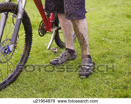 Muddy cyclist with bike, outdoors View Large Photo Image Stock Photo - Muddy cyclist with bike, outdoors. Fotosearch