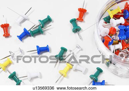 Multicolored Push Pins scattered by push pin jar on table, overhead view, close up View Large Photo Image Stock Photograph - Multicolored Push Pins scattered by push pin jar on table, overhead view, close up. Fotosearch