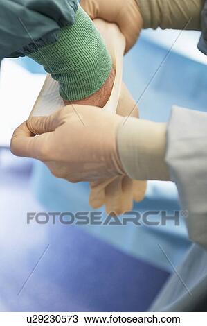 Nurse assisting surgeon Putting on Sterile Latex Gloves, close up of hands View Large Photo Image Stock Image - Nurse assisting surgeon Putting on Sterile Latex Gloves, close up of hands. Fotosearch