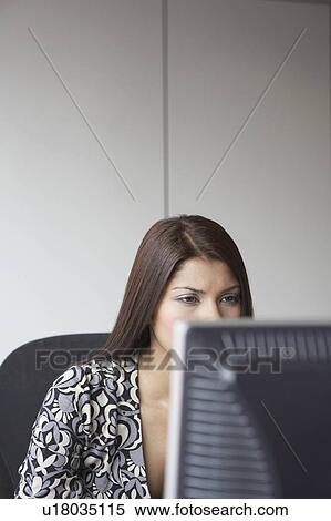 Office worker using computer View Large Photo Image Stock Photography - Office worker using computer. Fotosearch