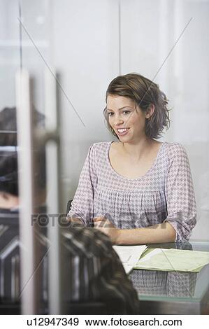 Office workers sitting at conference table View Large Photo Image Stock Photo - Office workers sitting at conference table. Fotosearch