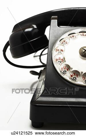 Stock Photography - Old fashioned black telephone in studio, cropped. Fotosearch
