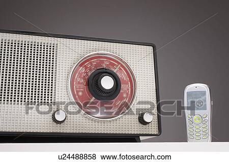 Stock Photo - Old Radio and a Cell Phone in studio. Fotosearch