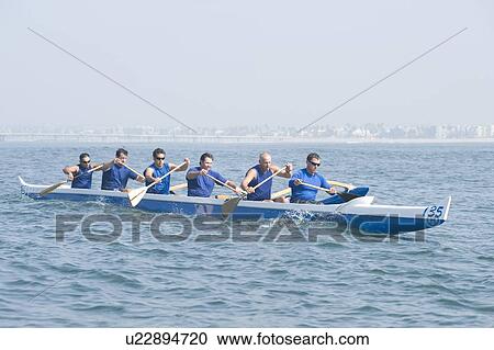 Outrigger canoeing team on water View Large Photo Image Stock Image - Outrigger canoeing team on water. Fotosearch