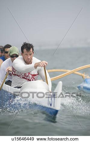 Stock Photo - Outrigger canoeing team on water. Fotosearch