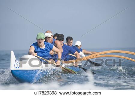 Outrigger canoeing team on water View Large Photo Image Stock Photo - Outrigger canoeing team on water. Fotosearch