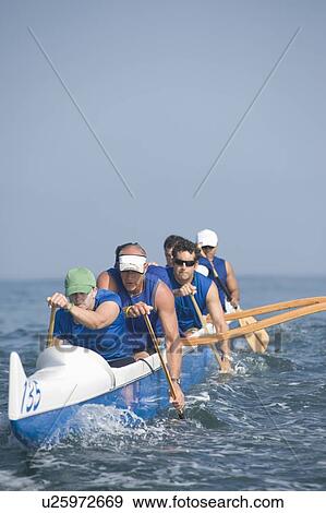 Outrigger canoeing team on water View Large Photo Image Stock Photo - Outrigger canoeing team on water. Fotosearch