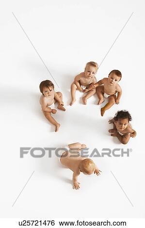Stock Photograph - Over head shot of small group of babies in white studio. Fotosearch