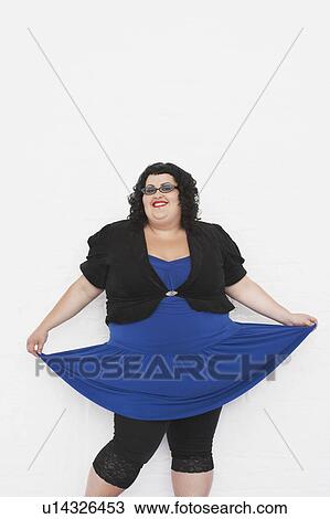 Stock Image - Overweight woman curtseying, portrait. Fotosearch