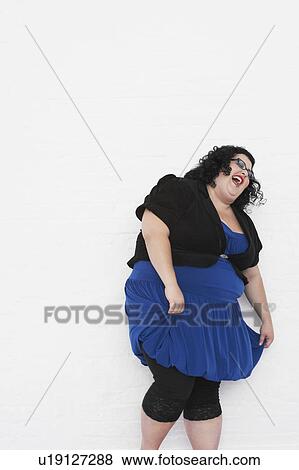 Stock Photo - Overweight Woman laughing while curtseying. Fotosearch