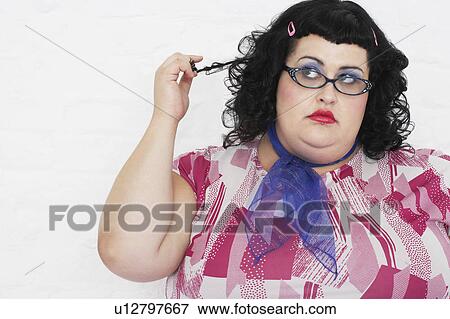 Overweight Woman twisting strand of hair, portrait View Large Photo Image Stock Photo - Overweight Woman twisting strand of hair, portrait. Fotosearch