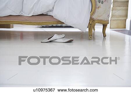 Stock Photo - Pair of slippers by bed. Fotosearch