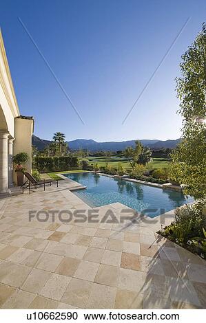 Paved poolside area and summer landscape View Large Photo Image Stock Image - Paved poolside area and summer landscape. Fotosearch