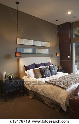 Stock Photo - Pendant lights in bedroom with silk furnishings. Fotosearch