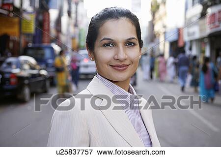 Stock Photo - Portrait of business woman on city street. Fotosearch