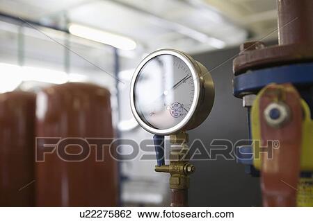 Stock Image - Pressure gauge in warehouse. Fotosearch