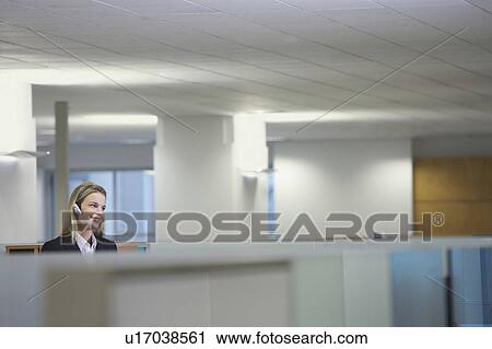 Receptionist sitting at reception desk View Large Photo Image Stock Image - Receptionist sitting at reception desk. Fotosearch