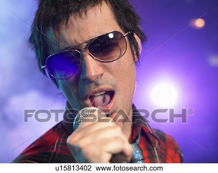 Stock Image - Rock Singer Performing on Stage. Fotosearch