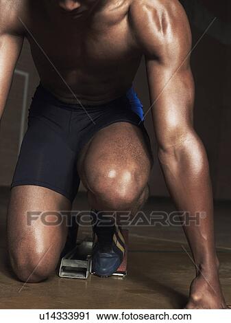 Runner crouching down, low section View Large Photo Image Stock Image - Runner crouching down, low section. Fotosearch