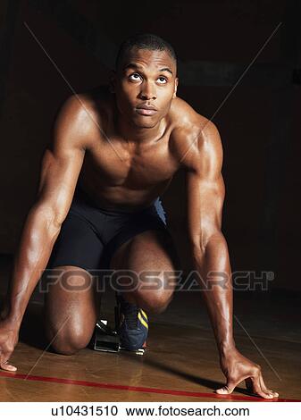 Runner crouching down, portrait View Large Photo Image Stock Image - Runner crouching down, portrait. Fotosearch