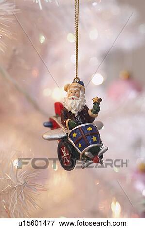 Stock Photo - Santa Christmas ornament hanging on tree. Fotosearch