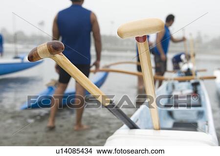 Sea kayak racing team prepare their boat View Large Photo Image Picture - Sea kayak racing team prepare their boat. Fotosearch
