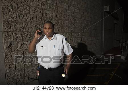 Security guard patrols with torch View Large Photo Image Stock Image - Security guard patrols with torch. Fotosearch