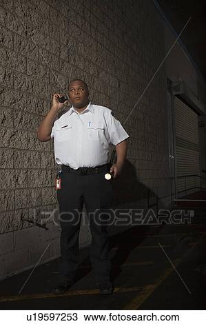 Security guard patrols with torch View Large Photo Image Stock Image - Security guard patrols with torch. Fotosearch