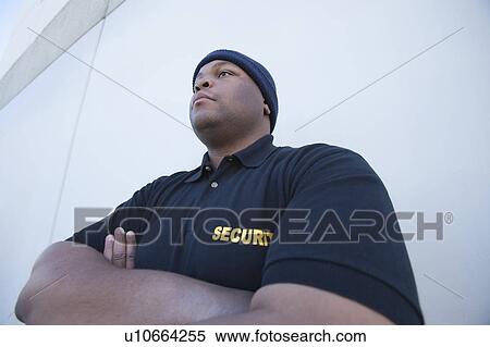 Security guard stands with arms folded View Large Photo Image Stock Photography - Security guard stands with arms folded. Fotosearch