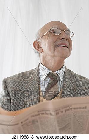 Senior man in spectacles reading newspaper, half length View Large Photo Image Stock Photo - Senior man in spectacles reading newspaper, half length. Fotosearch