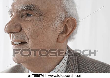 Stock Image - Senior man smiling in studio, close up. Fotosearch