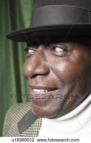 Stock Image - Senior Man Wearing a Hat in studio, close up. Fotosearch