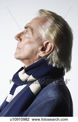 Stock Image - Senior Man Wearing a Scarf, head and shoulders, profile. Fotosearch