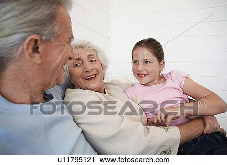 Senior woman hugging granddaughter with senior man, sitting in weatherboard room View Large Photo Image Stock Image - Senior woman hugging granddaughter with senior man, sitting in weatherboard room. Fotosearch