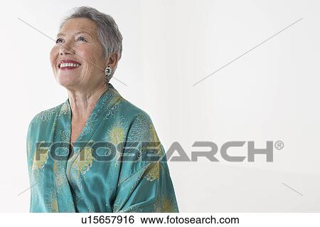 Senior woman in dressing gown in studio, half length View Large Photo Image Stock Photograph - Senior woman in dressing gown in studio, half length. Fotosearch