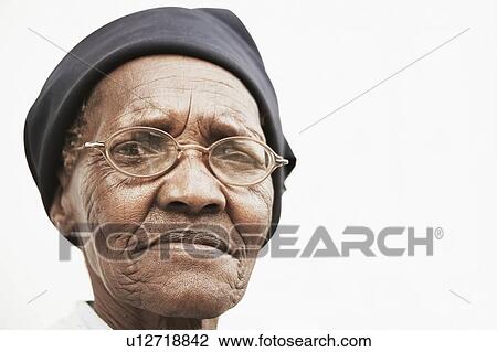 Stock Image - Senior woman in hat and spectacles. Fotosearch