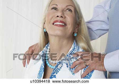 Senior woman in studio, head and shoulders, with man's hands on shoulders View Large Photo Image Stock Photo - Senior woman in studio, head and shoulders, with man's hands on shoulders. Fotosearch