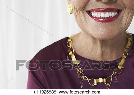 Stock Photography - Senior woman in studio, mid section. Fotosearch