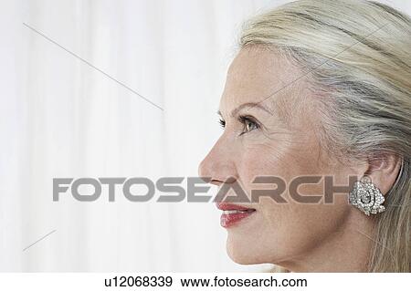 Stock Photo - Senior woman in studio, profile, close up. Fotosearch