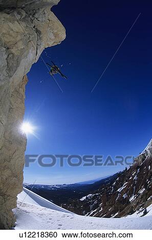 Skier jumping from mountain ledge View Large Photo Image Stock Image - Skier jumping from mountain ledge. Fotosearch
