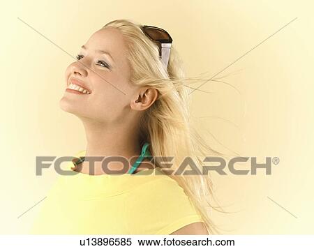 Smiling Woman, hair blowing, side view View Large Photo Image Stock Photography - Smiling Woman, hair blowing, side view. Fotosearch