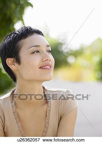 Smiling young woman in plaza courtyard View Large Photo Image Stock Photo - Smiling young woman in plaza courtyard. Fotosearch