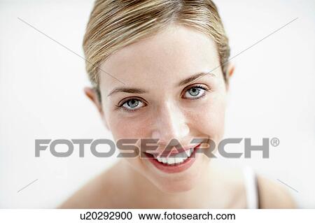 Stock Image - Smiling Young Woman, portrait, close up. Fotosearch